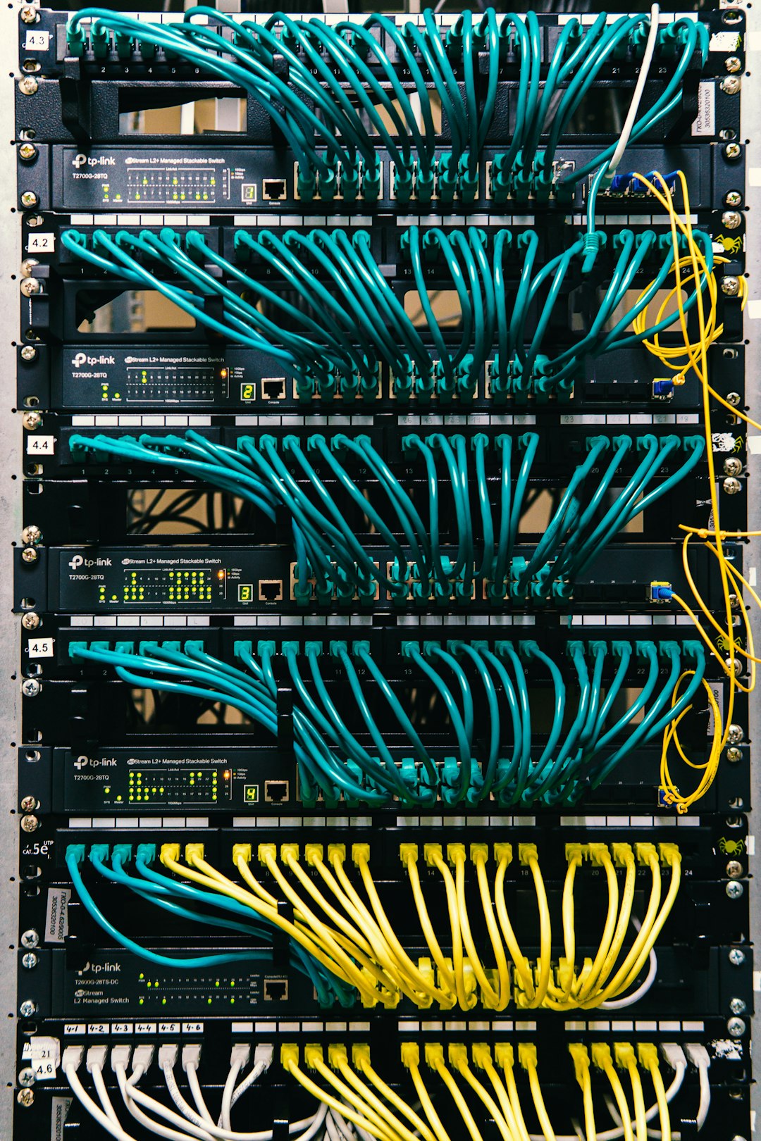 Home a-rack-of-servers-with-wires-and-wires-attached-to-them-c-lsqecd9oi